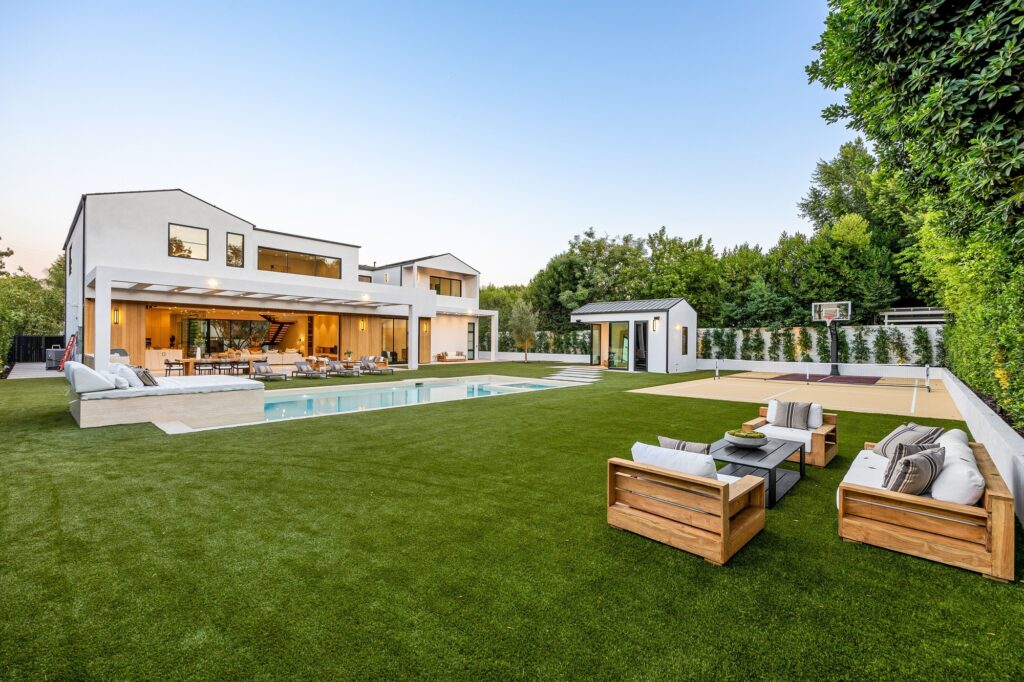 Modern luxury home with backyard and pool.